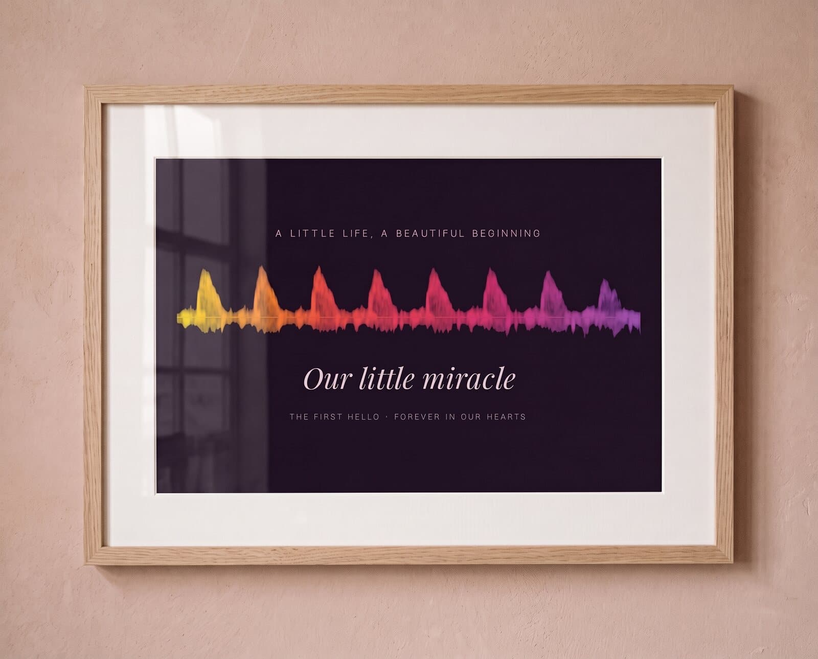 A framed heartbeat print on a blush wall (Sunset)